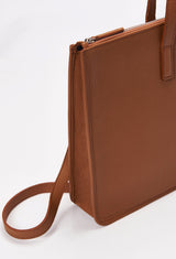 Partial photo of a Tan Leather Slim Briefcase with a detachable leather strap and a main zippered compartment.